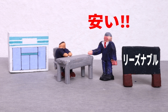 2体の人形とリーズナブルの看板と安いの文字